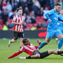 Sam Greenwood is tackled by Sheffield United's Sam McCallum