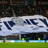 Preston North End fans with the giant Sir Tom Finney surfer flag