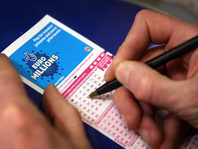 Filling out a lottery ticket.
