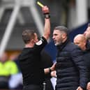 Preston North End's manager Ryan Lowe is yellow carded by referee David Webb