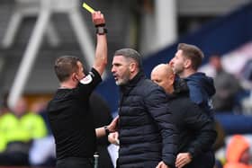Preston North End's manager Ryan Lowe is yellow carded by referee David Webb