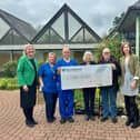 Representatives from St. John's hospice receiving the cheque
