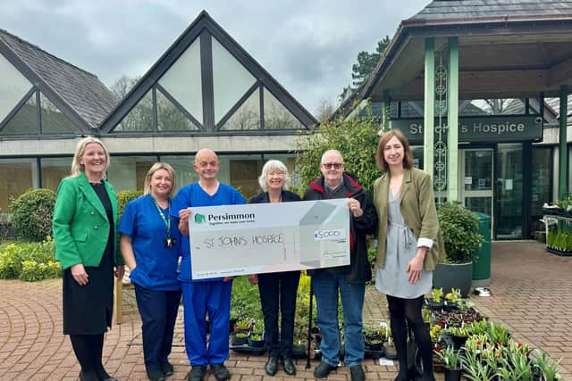 Representatives from St. John's hospice receiving the cheque