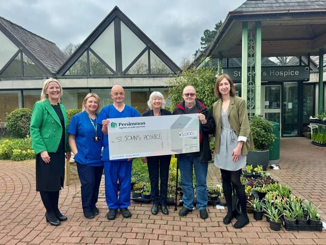 Representatives from St. John's hospice receiving the cheque