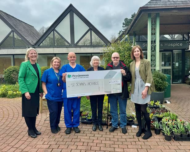Representatives from St. John's hospice receiving the cheque