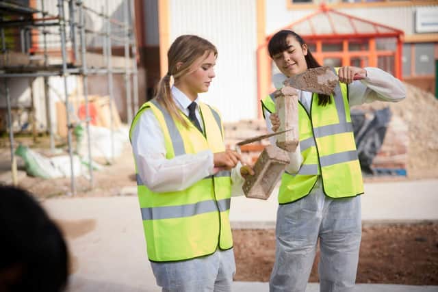 Participants try their hands at bricklaying at the 'Inspiring the Next Generation of Women in Construction' event at Preston College