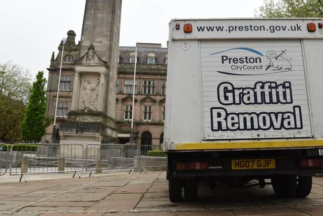 The council graffiti squad arrive to repair the damage.