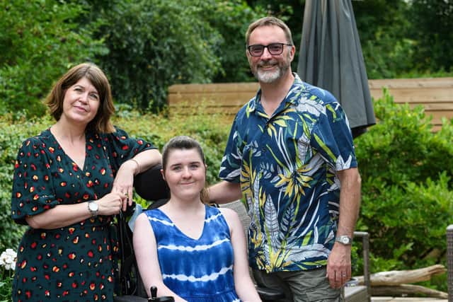 Ava Jolliffe pictured with mum Laura and dad Graham outside their new home which was bought with Ava's needs in mind.   Photo: Kelvin Stuttard