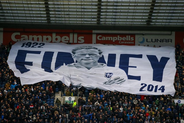 PNE fans in the Town End pass the Sir Tom Finney surfer flag over their heads