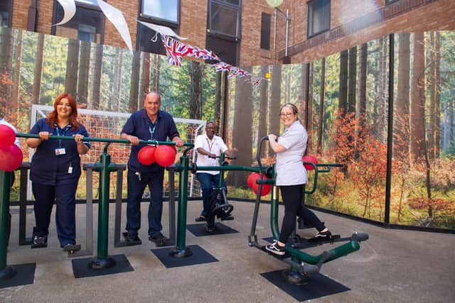 Members of staff using the new gym equipment