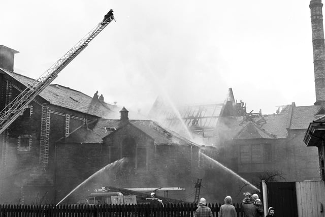 Onlookers watch as firemen fight flames at Murrays Brewery, in Craigmillar, in March 1966.
