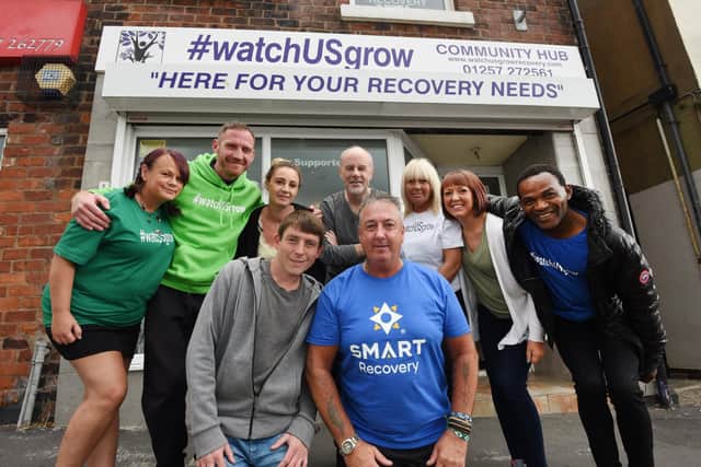 Recovering alcohol addict Steve Downie (front right), has been sober over two-years and now helps other addicts at Smart Recovery at WatchUSgrow community hub, Gillibrand Street, Chorley, pictured with staff, volunteers and members of the group .He is getting ready to open a second addiction centre in Clayton Brook Community Centre next month