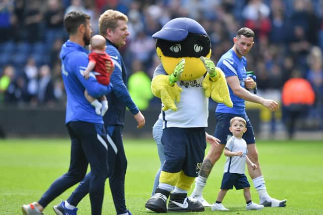 Preston North End skipper Alan Browne and his son Hugo have a walk with Deepdale Duck after the win against Middlesbrough