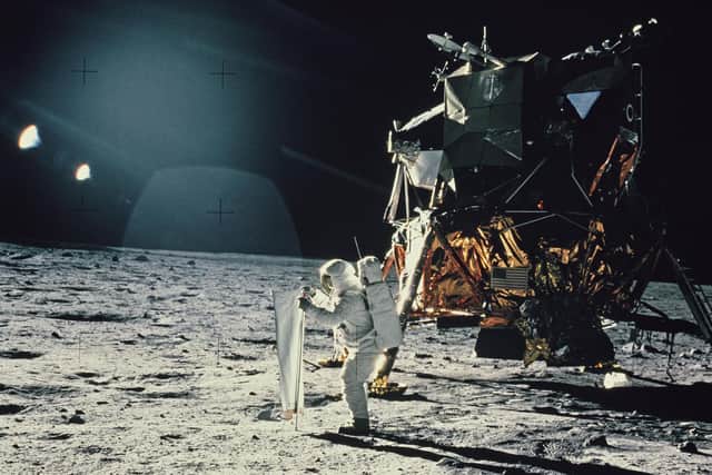 Lunar Module Pilot Edwin 'Buzz' Aldrin sets up the Solar Wind Composition experiment, part of the Early Apollo Scientific Experiments Package (EASAP), at Tranquility Base on the surface of the Moon, during NASA's Apollo 11 lunar landing mission, July 1969. The Lunar Module or 'Eagle' is behind him. (Photo by Space Frontiers/Getty Images)
