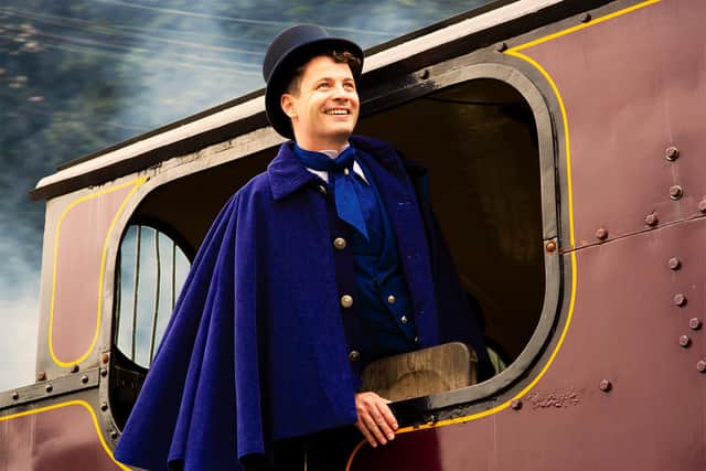 Philleas on a train engine in Around The World In 80 Days. Picture by Gabi Dawkins.