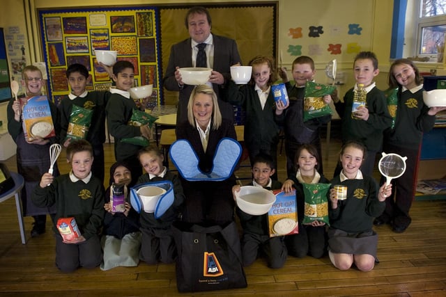 Aldi area manager Laura Cullen presents head teacher Gary Hayes and the after school cookery class at St Gregory's Catholic Primary School with goodies