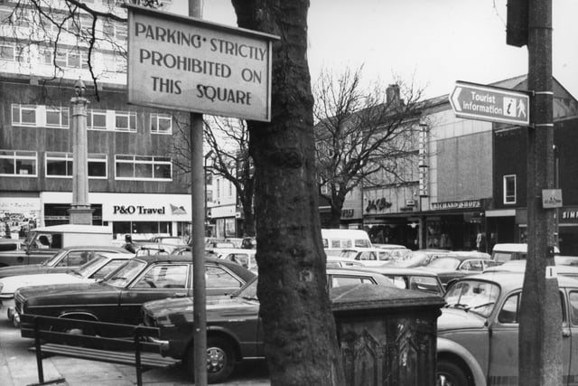 Cars parked on Preston's Flag Market in 1980 - despite signs in the area saying that parking is prohibited