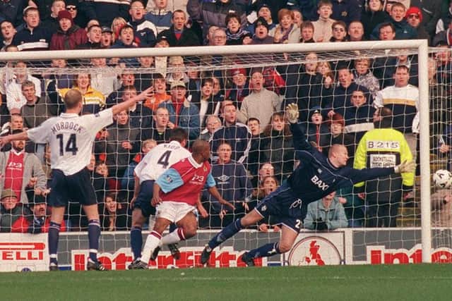 Burnley's Ian Wright heads wide, with PNE keeper Tepi Moilanen diving to cover the post