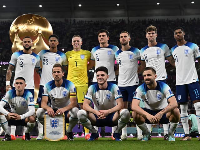 England players pose for a squad photo ahead of their Group B clash with Wales - with a 3-0 victory in the game setting up a last-16 tie with Senegal. (Photo by PAUL ELLIS/AFP via Getty Images)