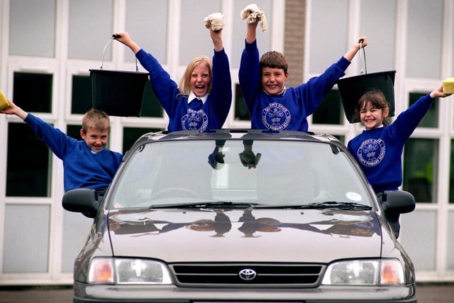 Queens Drive Primary School after school club members, from left, Aaron White, eight, Laura Cutts, nine, Alex Titterington, eight, and Hannah Beswick, six, prepare to start the sponsored car wash, at the school in Fulwood, Preston, to raise money for Guide Dogs for the Blind in 1997