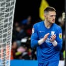 Freddie Woodman applauds the travelling supporters at the end of the match