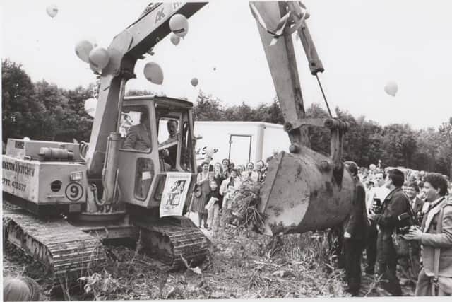 Ken Dodd gets behind a JCB to dig the hospice foundations at the 1992 ceremony.