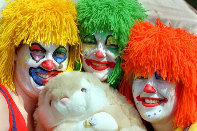 Catterall clowns, Kath Wrathall, Irene Hall and Anne Taylor, grow attached to this cuddly bunny on the tombola stall at the village's gala