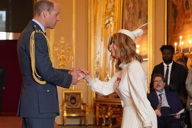 Kate Garraway is watched by her husband Derek Draper, born and raised in Chorley, as she is made a Member of the Order of the British Empire by the Prince of Wales at Windsor Castle. The honour recognises services to broadcasting, to journalism and to charity.  Picture by Jonathan Brady/PA Wire