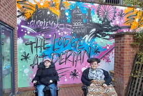 Kirk and Connor checking out the new graffiti wall at Derian House. The wall was created by street artist Simon Daly