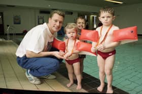 More than 600 Preston swimmers took the plunge to raise cash for the Olympics. Swimmers young and old waded in to make more than £6,000 for the British Olympic Association. Picture shows Olympic silver medalist Nick Gillingham giving medals to three young swimmers. From left are Mairi McGilverary, two, Jason Watson, three, and Hugh McGilveray, four