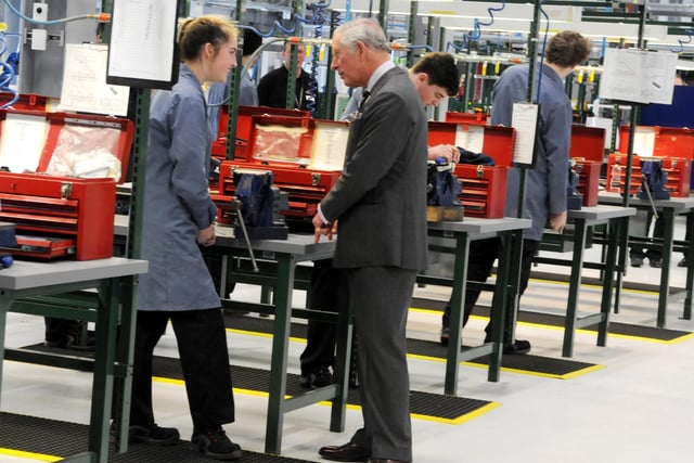 HRH Prince Charles chats to apprentices in the workshop, during his visit to BAE Systems Academy in 2017