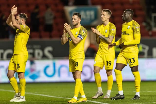 Preston North End players applaud their side's travelling supporters at the end of the match.