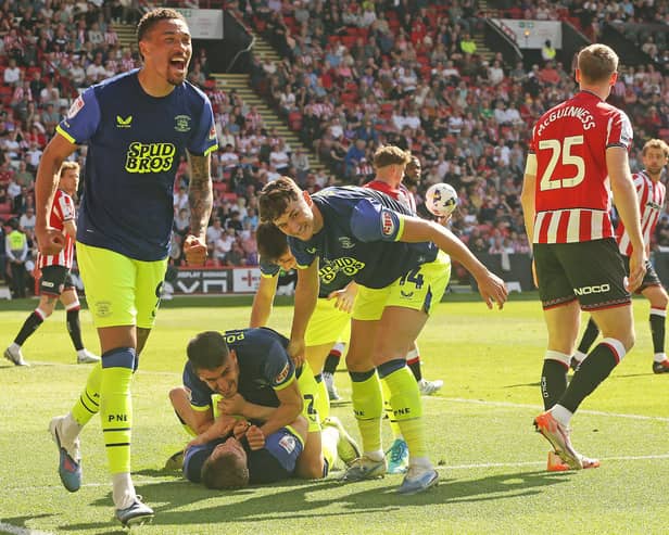 Preston North End's Liam Lindsay (grounded) is mobbed by team-mates after scoring his side's second goal at Sheffield United (photo: Rich Linley/CameraSport)