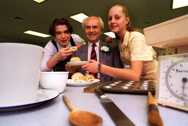 Former headmaster at Ashton on Ribble High School, Preston, Harry Eccles, samples some of the work of pupils in the cookery classrooms which are part of the new building he officially opened. He is joined by pupils David Martin and Emma Fitzgerald