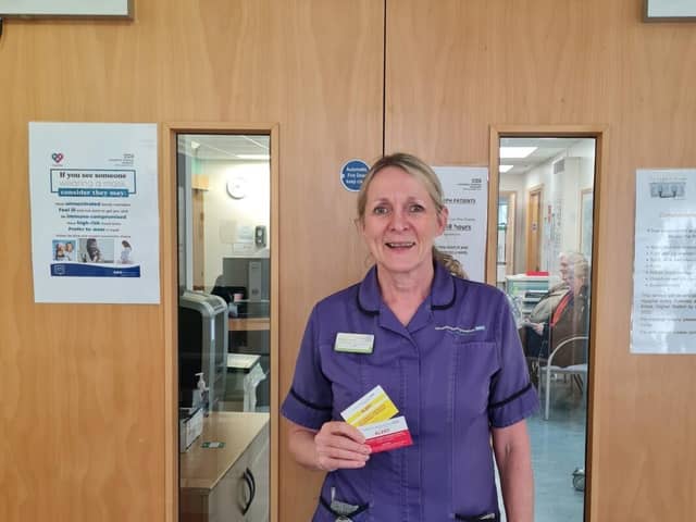 Lead chemotherapy acute oncology nurse specialist Jo Wilkinson with new alert cards funded by  Rosemere Cancer Foundation