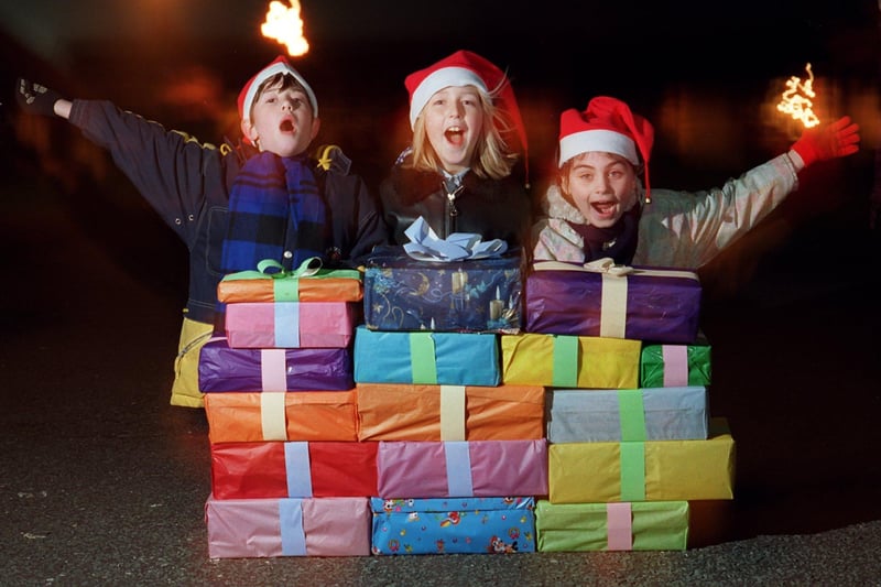 Kennington Primary School pupils, from left, Francis Hills, nine, Kimberley Horton, 11, and Lucy McHale, nine, who along with schoolmates sang carols and gave food parcels to the residents of Poole Road Sheltered Accommodation in Fulwood, Preston