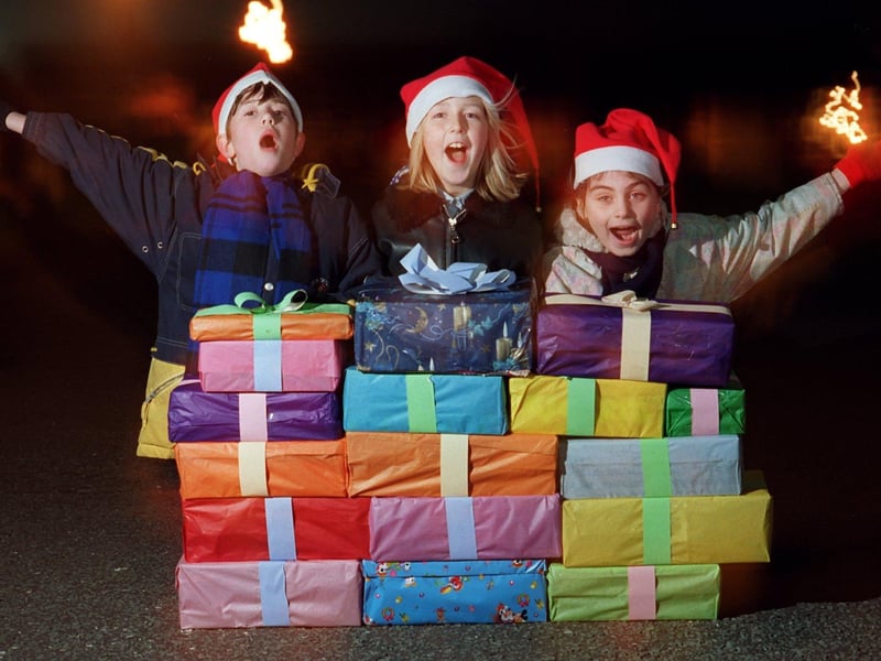 Kennington Primary School pupils, from left, Francis Hills, nine, Kimberley Horton, 11, and Lucy McHale, nine, who along with schoolmates sang carols and gave food parcels to the residents of Poole Road Sheltered Accommodation in Fulwood, Preston
