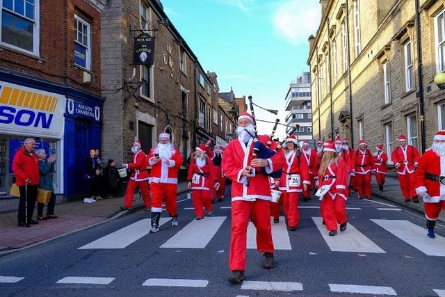 Passersby couldn't believe their eyes when a sea of Santas marched past them