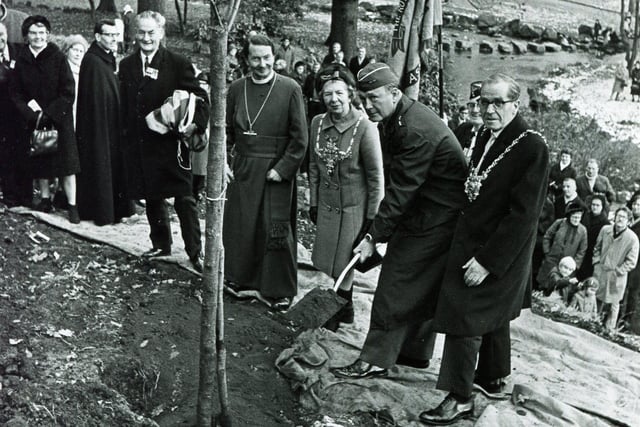 After unveiling the memorial, Major General John H Bell (Commander 3rd American Air Force) plants a memorial tree, November 30th 1969