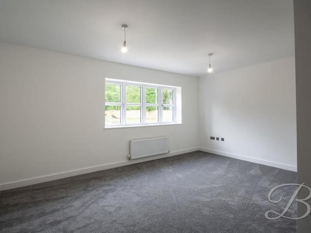 Here is the second bedroom at the Longdale Lane house. Again it has carpeted flooring, a central heating radiator, a window overlooking the back garden and access to an en suite.