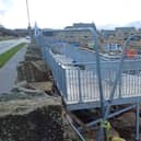 The housing developer responsible for constructing a metal walkway, that has been blasted as a ‘monstrosity’ on a new housing estate in Burnley, has said today it is still in the ‘early stages of construction.’