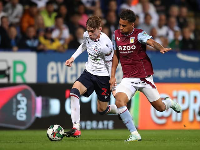 Conor Bradley of Bolton Wanderers battles with Douglas Luiz of Aston Villa during the Carabao Cup Second Round