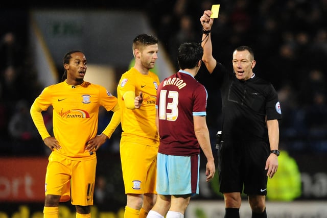 Burnley’s Joey Barton is shown a yellow card by referee Kevin Friend