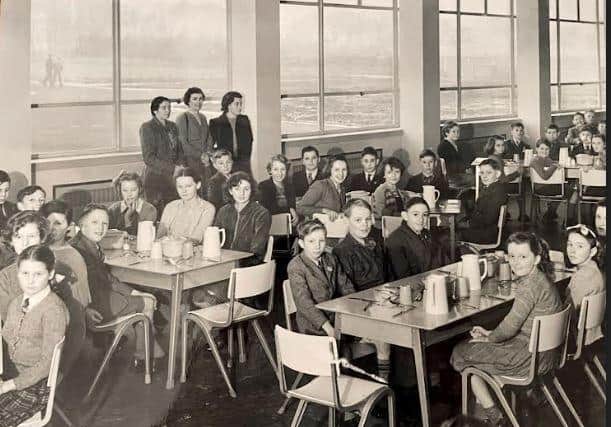 In this picture of the dining hall from around 1953, Sonia is the girl in the light cardigan below the left lady at the window.