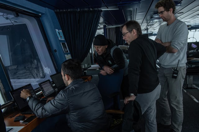 Falklands Maritime Heritage Trust of MarcDe Vos (left), Senior Meteorologist and Oceanographer from South African Weather Service, showing the weather data to Jean-Christope Caillens, Off-Shore Manager, Nico Vincent, Expedition Sub-sea Manager and Lasse Rabenstein, Chief Scientist on the bridge of S.A. Agulhas II during the expedition to find the wreck of Endurance.