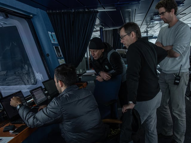 Falklands Maritime Heritage Trust of MarcDe Vos (left), Senior Meteorologist and Oceanographer from South African Weather Service, showing the weather data to Jean-Christope Caillens, Off-Shore Manager, Nico Vincent, Expedition Sub-sea Manager and Lasse Rabenstein, Chief Scientist on the bridge of S.A. Agulhas II during the expedition to find the wreck of Endurance.