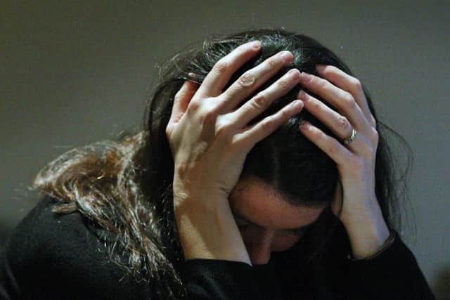 PICTURE POSED BY A MODEL.
File photo dated 08/11/07 of a woman holding her head in her hands. The number of young people admitted to adult mental health wards has increased since last year, a new report has shown. Eighty young people were admitted to primarily adult wards for mental health treatment in 2021-22, up from 62 in 2020-21. Issue date: Thursday December 1, 2022. PA Photo. See PA story SCOTLAND MentalHealth. Photo credit should read: David Cheskin/PA Wire