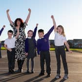 Pupils from Trinity School in Buckshaw Village celebrate their school receiving a good rating from Ofsted with head teacher Mrs Jill Wright.