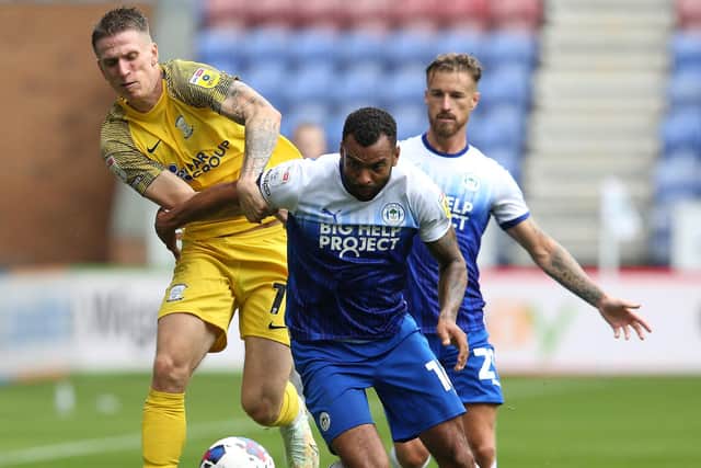 Preston North End's Emil Riis  battles with Wigan Athletic's Curtis Tilt.
