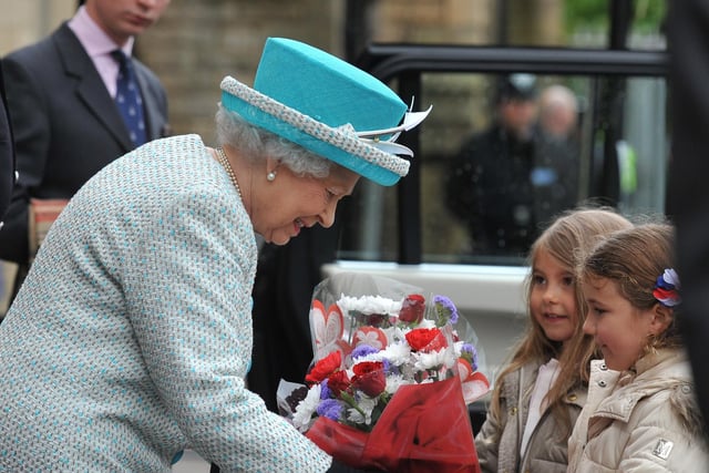 Ava Reed and Poppy Dodds present a bouquet to the Queen during her visit to Lancaster in 2015